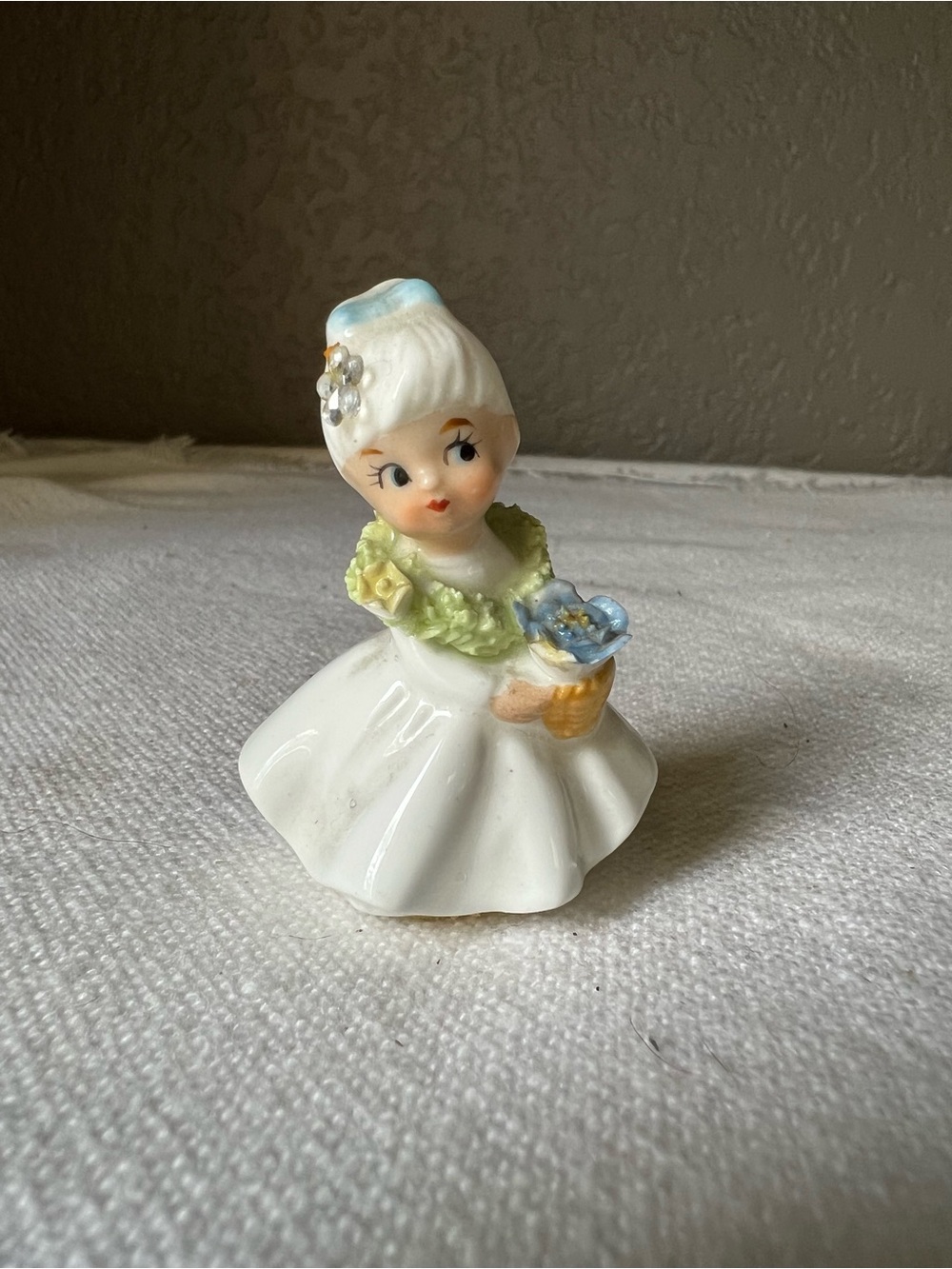 vintage Napcoware bone china figurine of a girl holding a basket of flowers